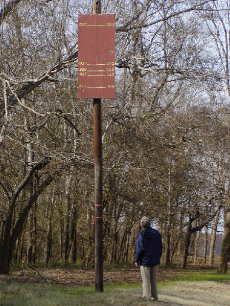 Flood levels on the lower Mississippi River are almost beyond belief. Here, Rich is studying a flood level marker for several different years.