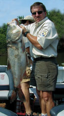 Man holding large Asian carp. We joke about the flying carp, but it would be no joke to be hit by an 80 pounder! And some day, the Mississippi River will be full of them!!!