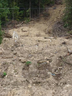 This landslide washed away a new home on Hwy 35 south of La Crosse, Wisconsin. A single wall remains: about 1/3 down the photo on the left side is a gray wall.