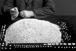 A pearl buyer with his harvest of "chicken feed" (PEARL) for the day.