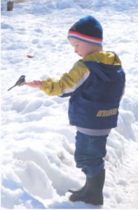 child with chickadee winter